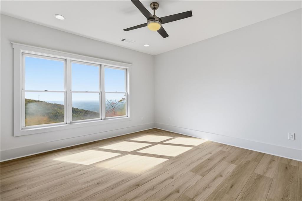 5510 Monument Road Jasper, GA 30143 - Photo 31 of 58 an empty room with wooden floor and windows