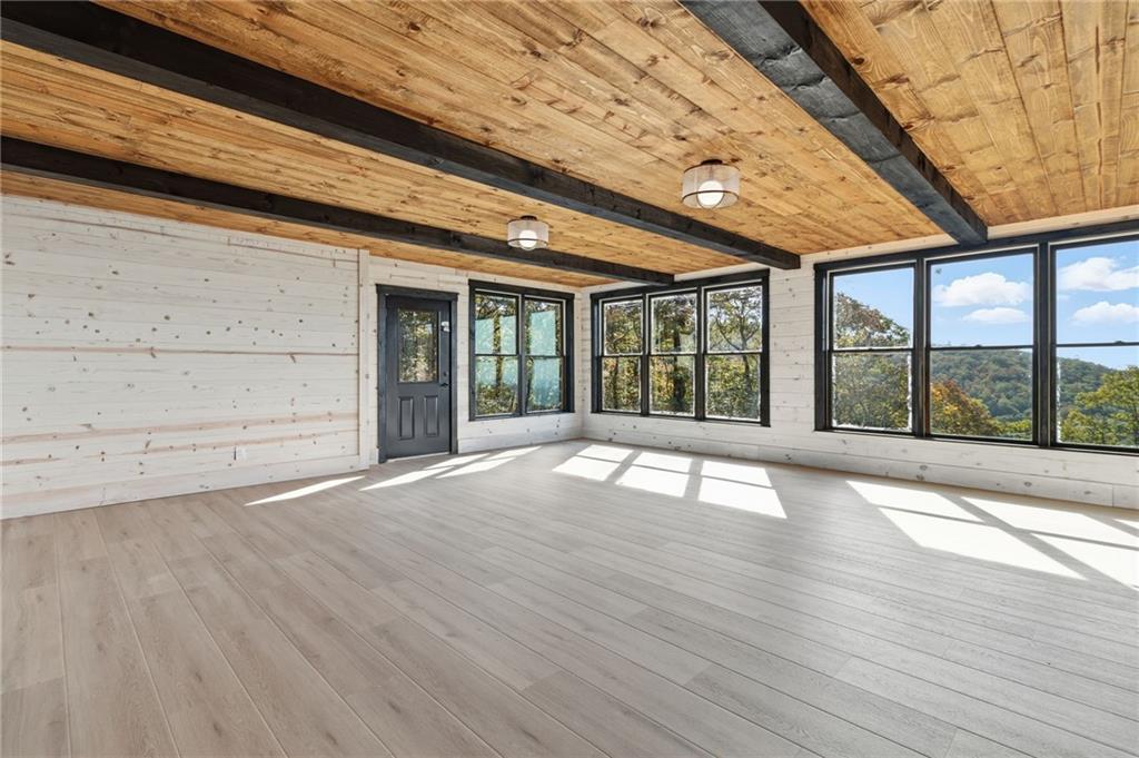 5510 Monument Road Jasper, GA 30143 - Photo 34 of 58 a view of an empty room with wooden floor and a window