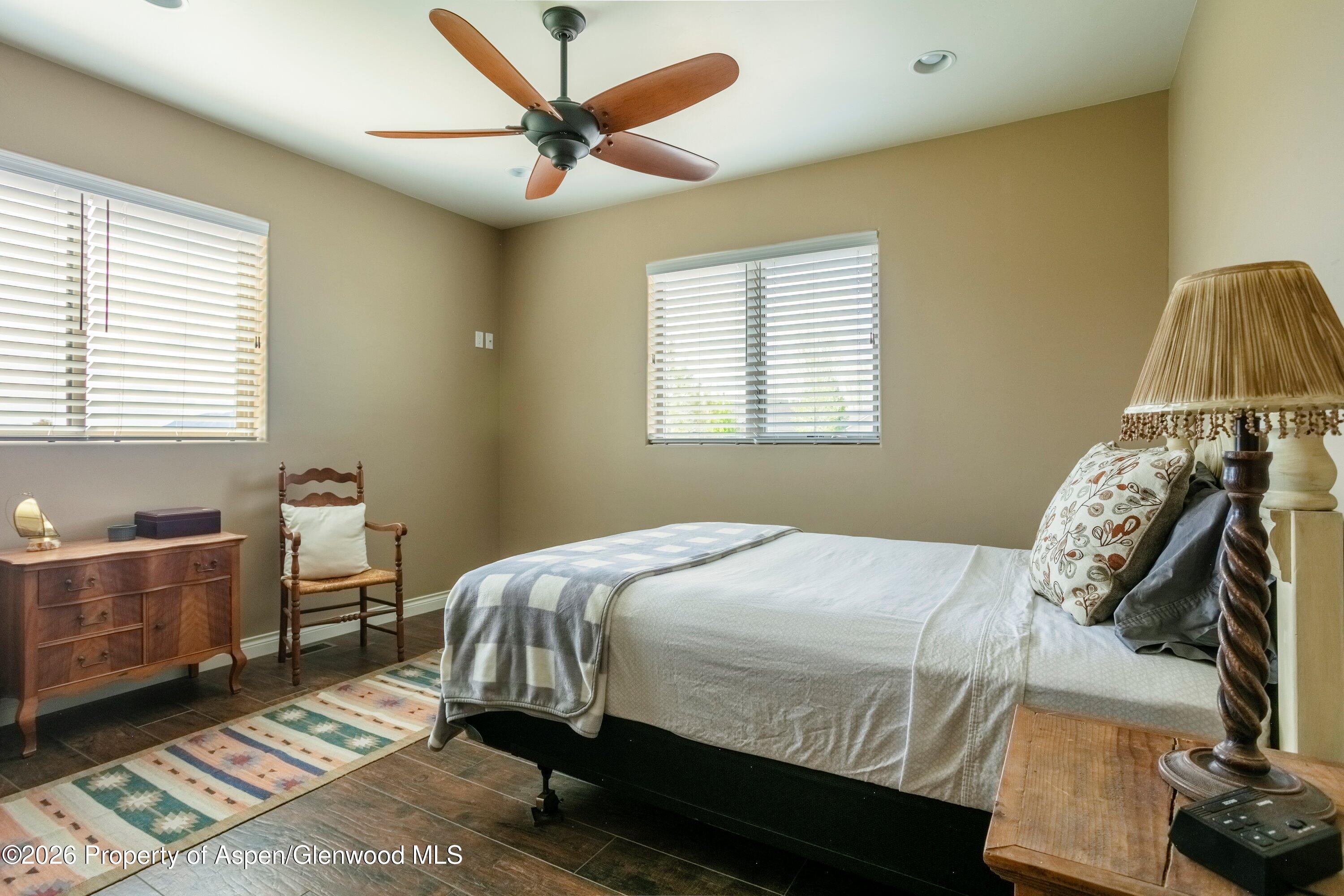 265 South Meadow Drive Rifle, CO 81650 - Photo 60 of 76 a bedroom with a bed and a chandelier