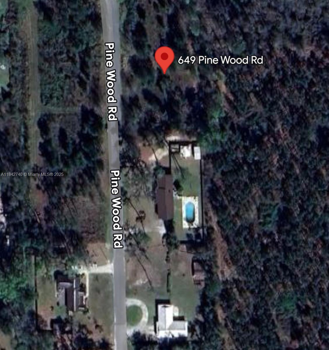 649 Pine Wood Road Jasper, FL 32052 - Photo 2 of 3 a street sign that is on a tree