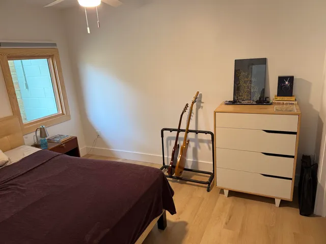 a bedroom with a bed and a mirror