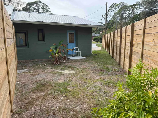 a view of a porch with furniture and garden