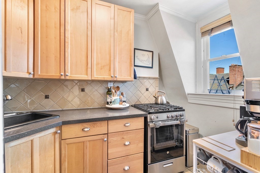 24 Harvard Street, Unit 4 Boston, MA 02129 - Photo 6 of 17 a kitchen with granite countertop a stove and a sink