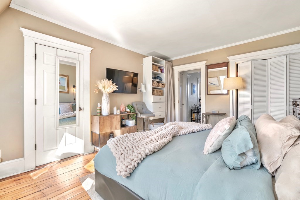 24 Harvard Street, Unit 4 Boston, MA 02129 - Photo 8 of 17 a bedroom with a bed and wooden floor