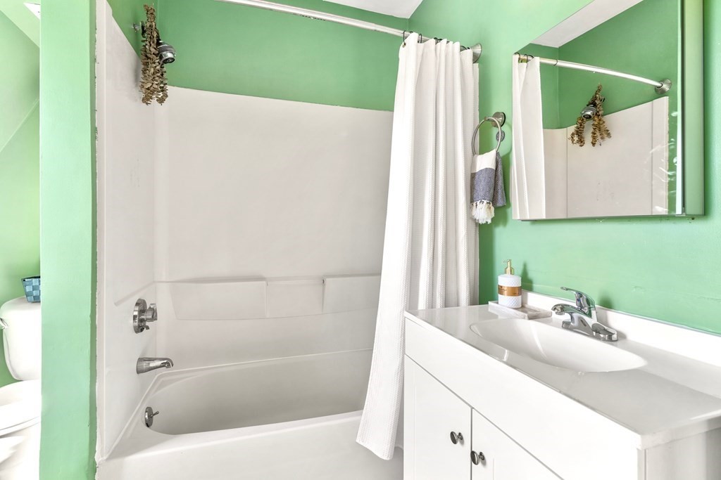 24 Harvard Street, Unit 4 Boston, MA 02129 - Photo 9 of 17 a bathroom with a sink and a mirror