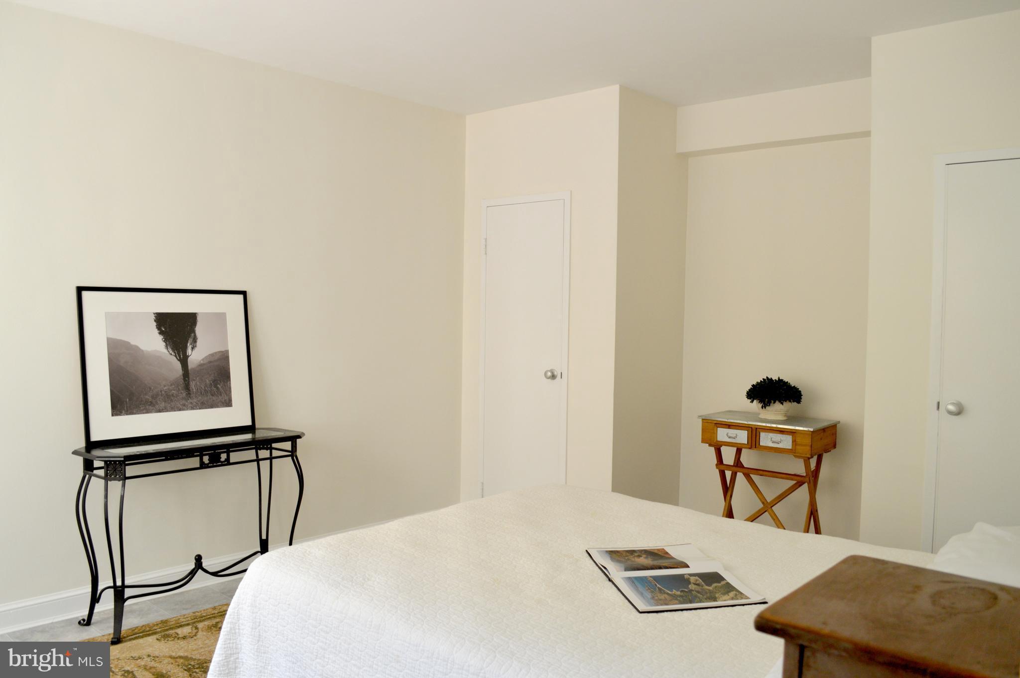3025 Ontario Road Northwest, Unit 105 Washington, DC 20009 - Photo 11 of 26 a bedroom with a bed and a window