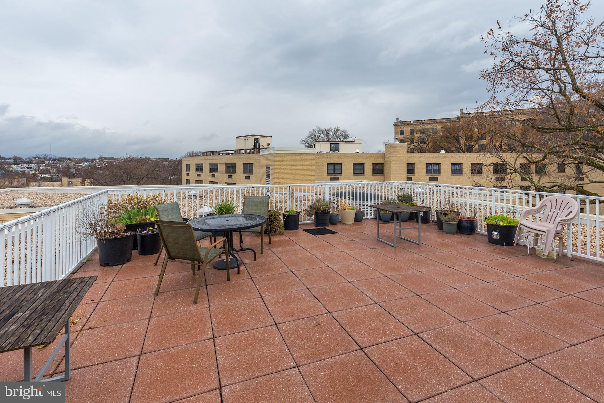 3025 Ontario Road Northwest, Unit 105 Washington, DC 20009 - Photo 18 of 26 a terrace with outdoor seating and city view