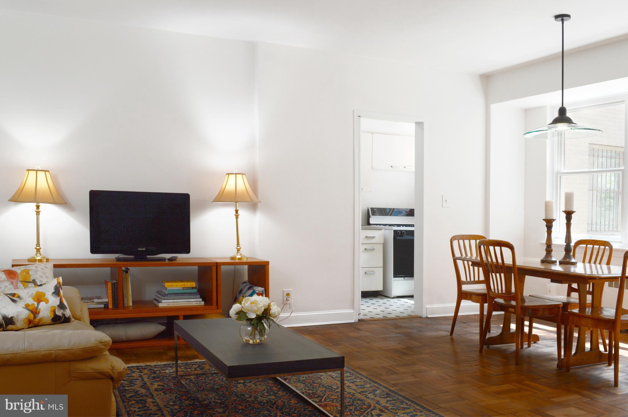 3025 Ontario Road Northwest, Unit 105 Washington, DC 20009 - Photo 3 of 26 a living room with furniture and a flat screen tv