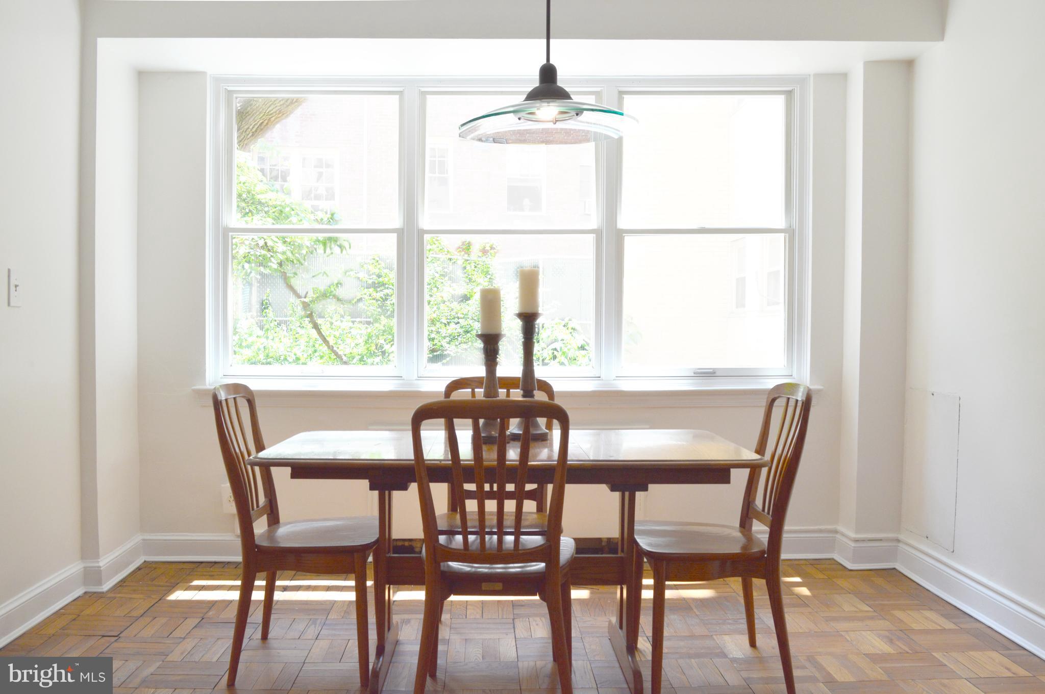 3025 Ontario Road Northwest, Unit 105 Washington, DC 20009 - Photo 4 of 26 a dining room with furniture window and outside view