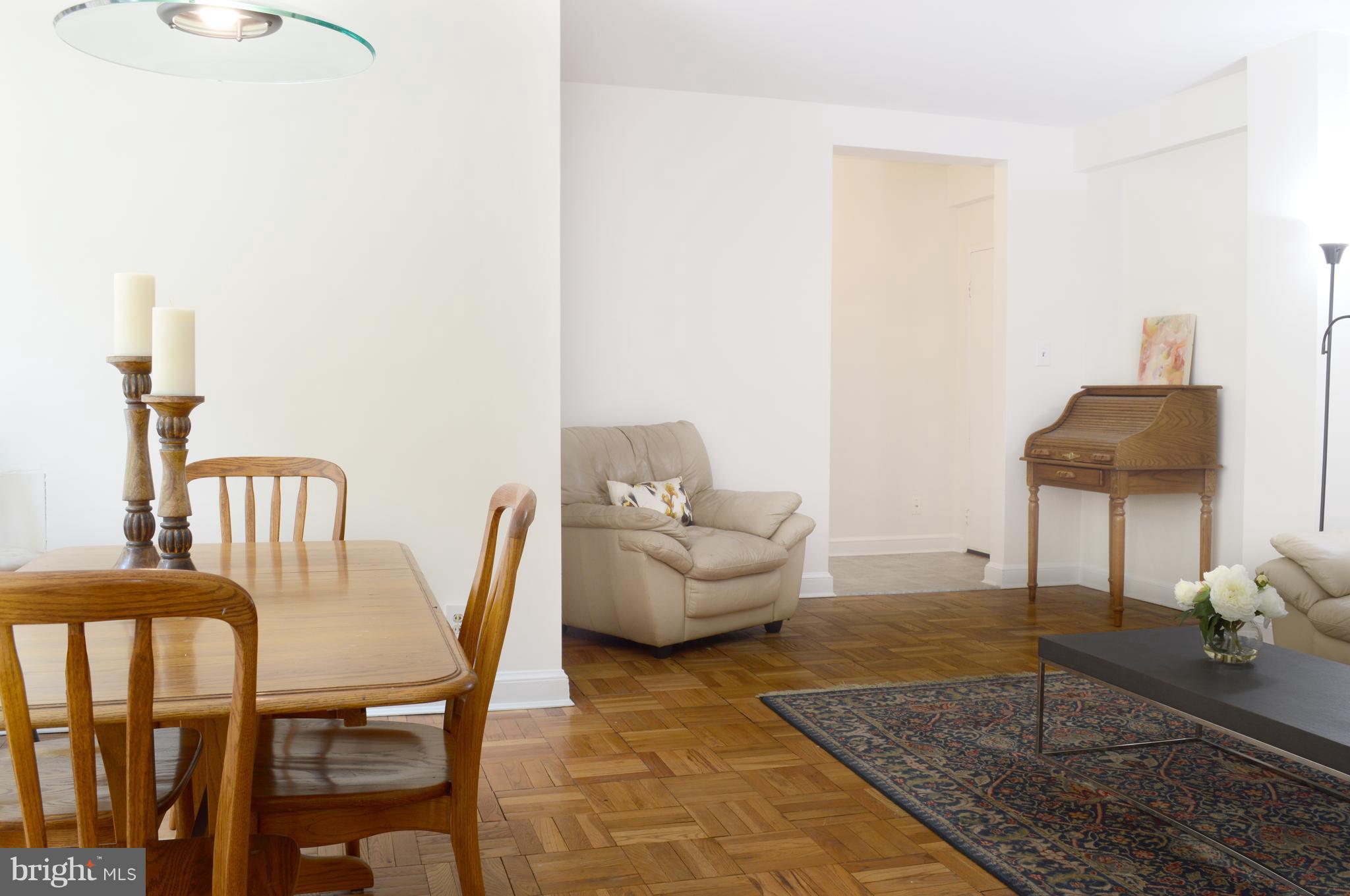 3025 Ontario Road Northwest, Unit 105 Washington, DC 20009 - Photo 5 of 26 a living room with furniture and a rug