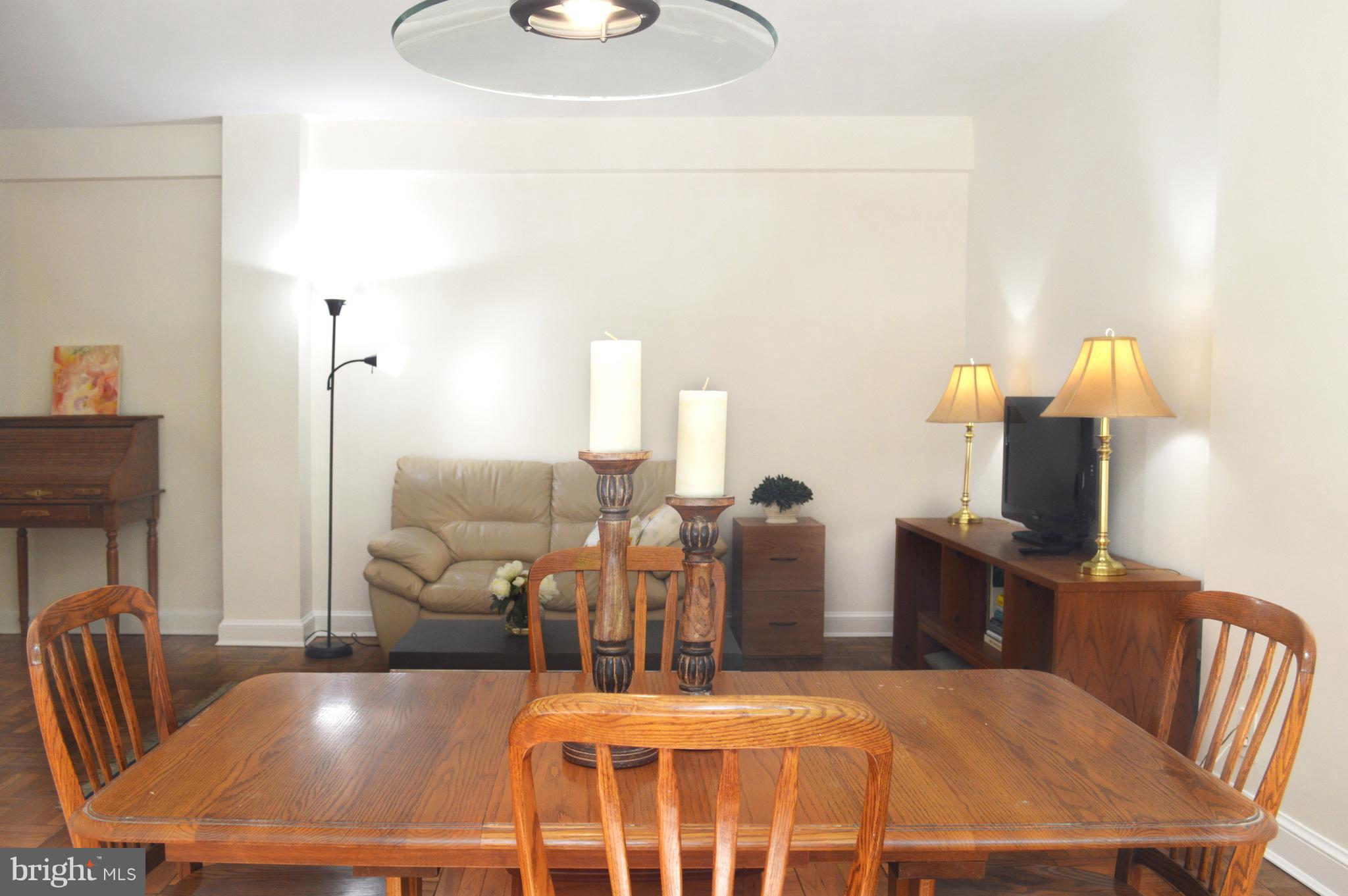 3025 Ontario Road Northwest, Unit 105 Washington, DC 20009 - Photo 6 of 26 a living room with furniture a flat screen tv and a fireplace