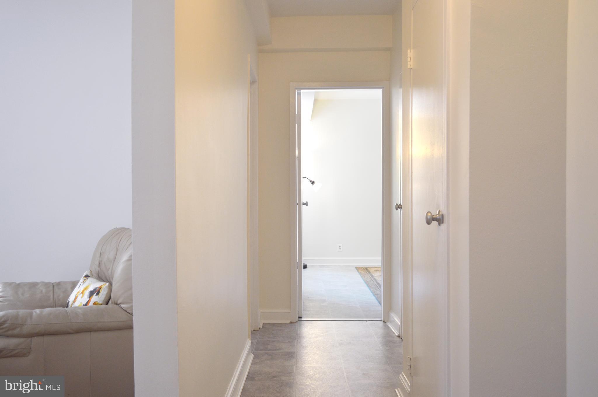 3025 Ontario Road Northwest, Unit 105 Washington, DC 20009 - Photo 7 of 26 a view of room with couch and wooden floor