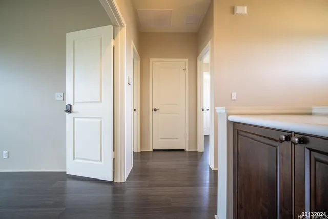 an empty room with wooden floor and a cabinet