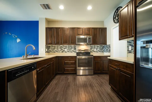a kitchen with stainless steel appliances and wooden cabinets
