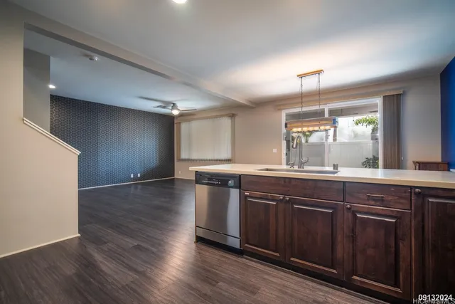 a large kitchen with wooden floors and wooden cabinets