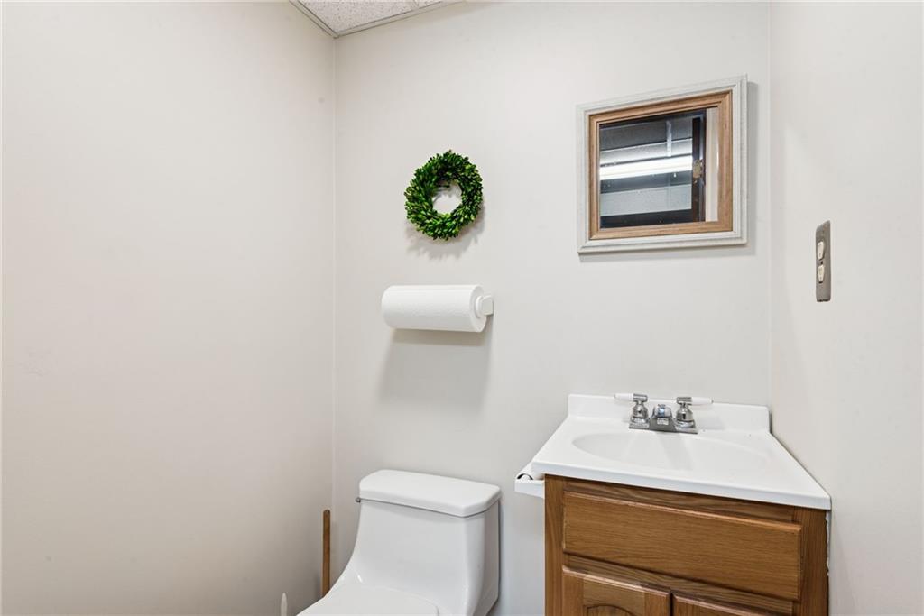 7814 Highway 30 Irwin, PA 15642 - Photo 12 of 30 a bathroom with a toilet a sink and mirror