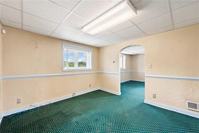 a view of a room with window and a wooden floor