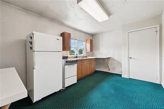 a view of a room with an empty space and a window