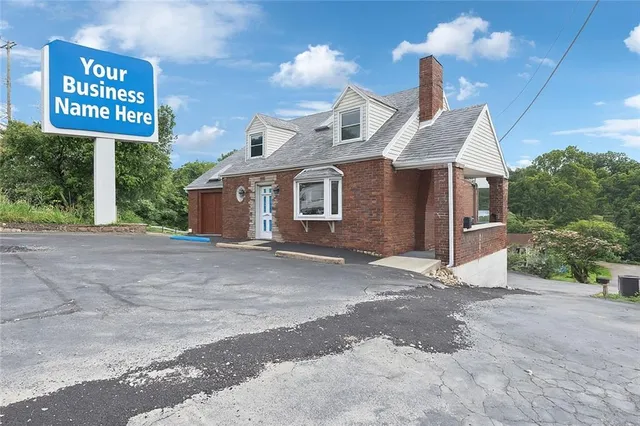 a view of a house with a yard and garage