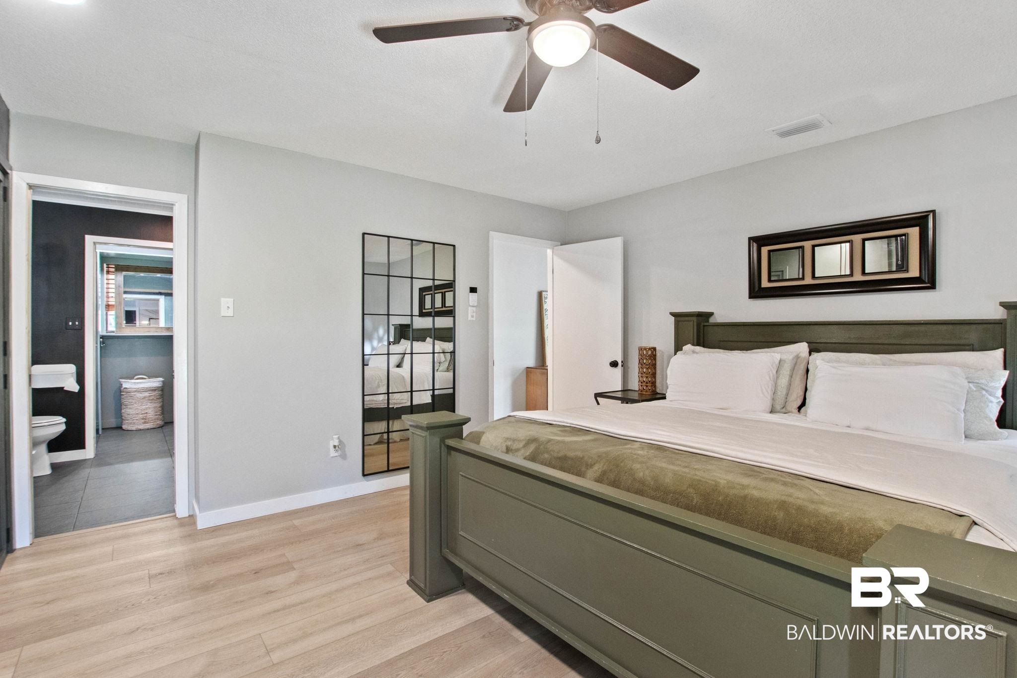 524 Ariel Avenue Foley, AL 36535 - Photo 15 of 37 Bedroom featuring light wood-finish flooring, a ceiling fan with integrated lighting, and a white paneled door