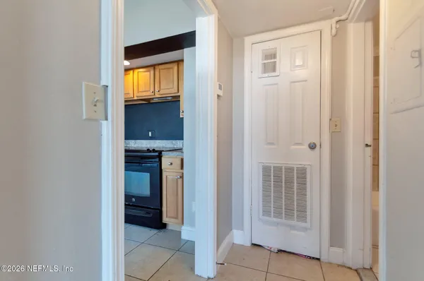 a kitchen with granite countertop a stove top oven microwave and cabinets