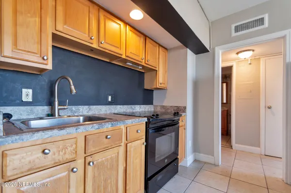 a kitchen with cabinets and window