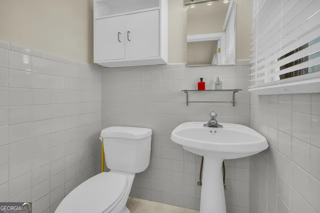 a bathroom with a sink mirror and a shower