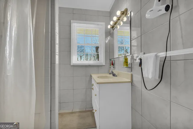 a kitchen with granite countertop white cabinets white appliances and sink