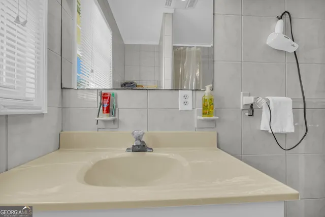 a kitchen with granite countertop a sink and a stove top oven