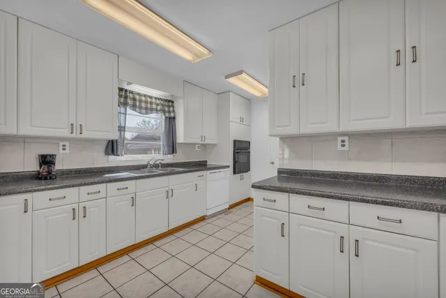 a kitchen with stainless steel appliances granite countertop a refrigerator and a stove