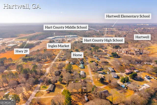 a view of swimming pool with a table and chairs under an umbrella