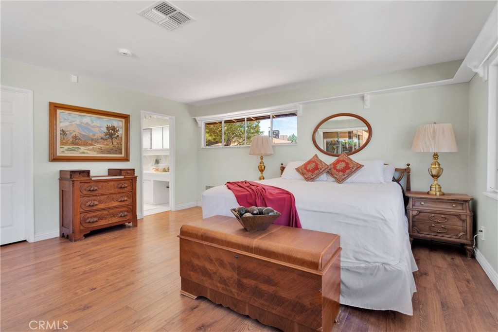 19955 Chickasaw Road Apple Valley, CA 92307 - Photo 23 of 60 a bedroom with a bed and wooden floor