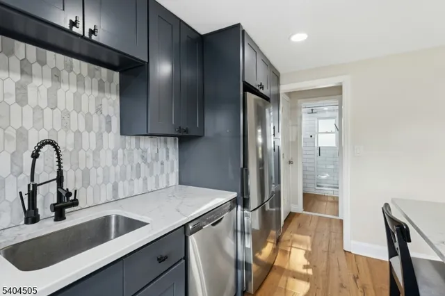 a kitchen with a sink and a refrigerator