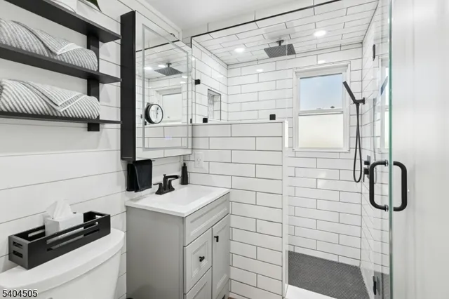 a bathroom with a sink a toilet and shower