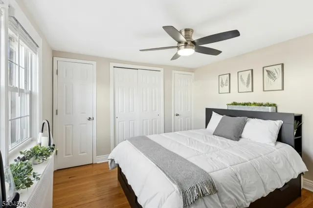 a bedroom with a bed and ceiling fan