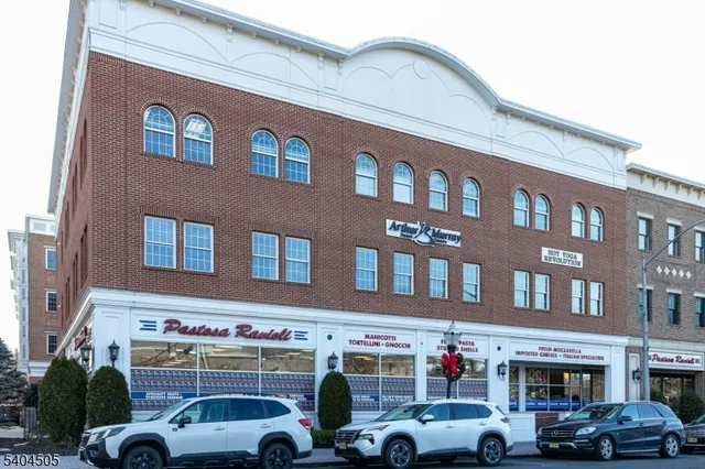 a front view of a building with parking