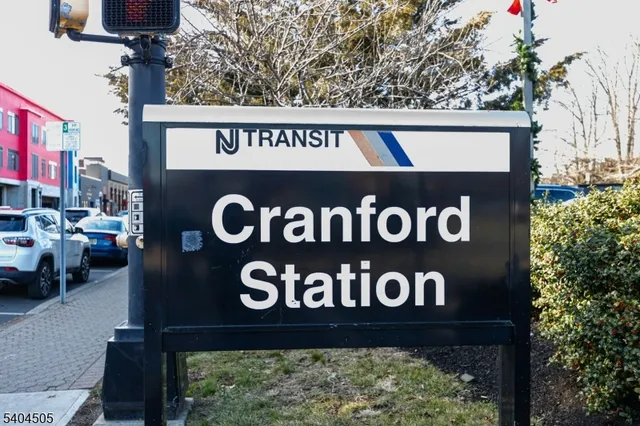 a street sign on a wall next to a road