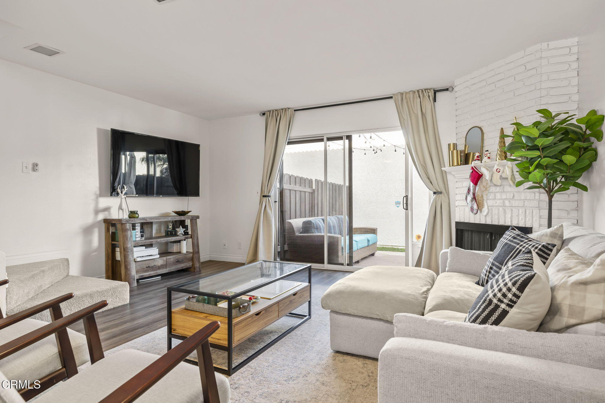 3255 Kelp Lane Oxnard, CA 93035 - Photo 2 of 45 a living room with furniture a flat screen tv and a floor to ceiling window