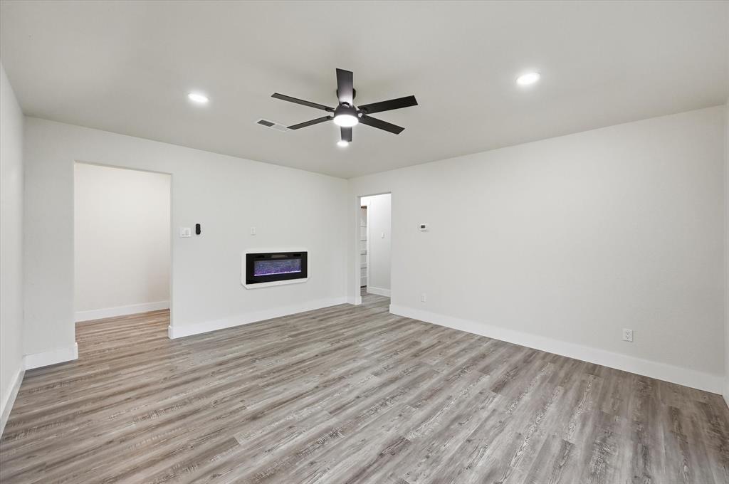 2804 Bent Tree Lane Arlington, TX 76016 - Photo 15 of 32 a view of an empty room with wooden floor