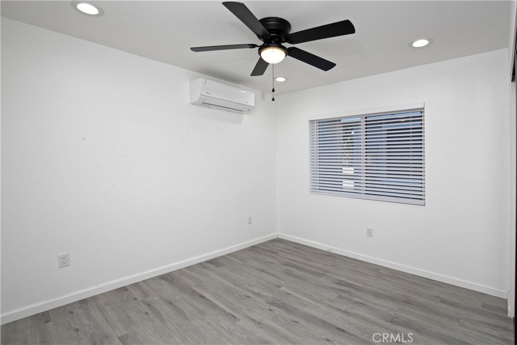 6147 Palm Avenue Riverside, CA 92506 - Photo 2 of 13 wooden floor in an empty room with a window