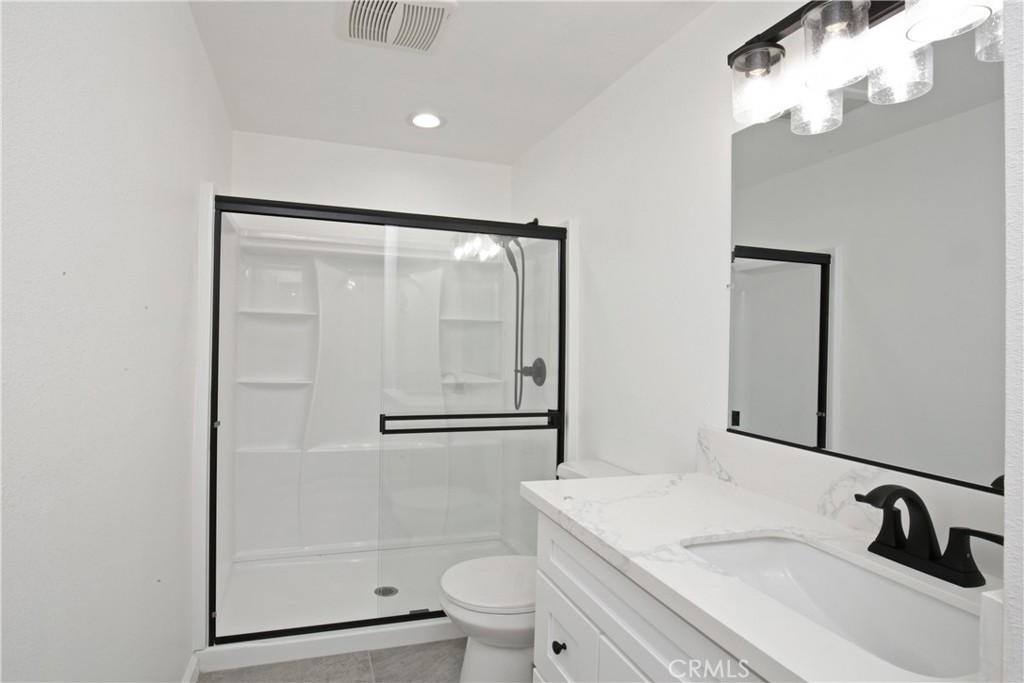 6147 Palm Avenue Riverside, CA 92506 - Photo 4 of 13 a bathroom with a sink a toilet and shower
