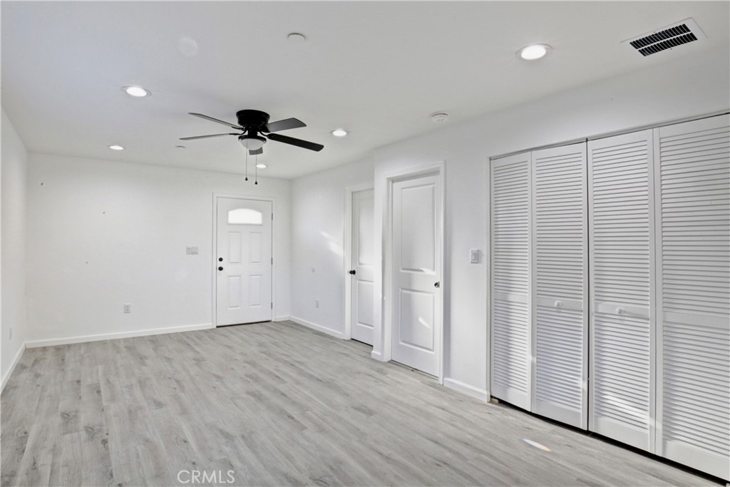 6147 Palm Avenue Riverside, CA 92506 - Photo 6 of 13 an empty room with wooden floor and ceiling fan