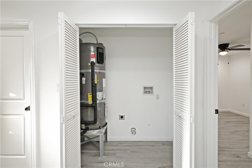 6147 Palm Avenue Riverside, CA 92506 - Photo 8 of 13 a view of a hallway with entryway and livingroom with wooden floor
