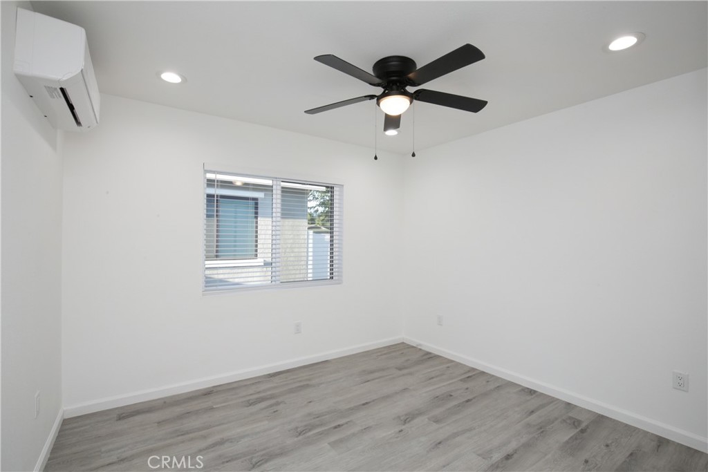 6147 Palm Avenue Riverside, CA 92506 - Photo 9 of 13 an empty room with wooden floor fan and windows