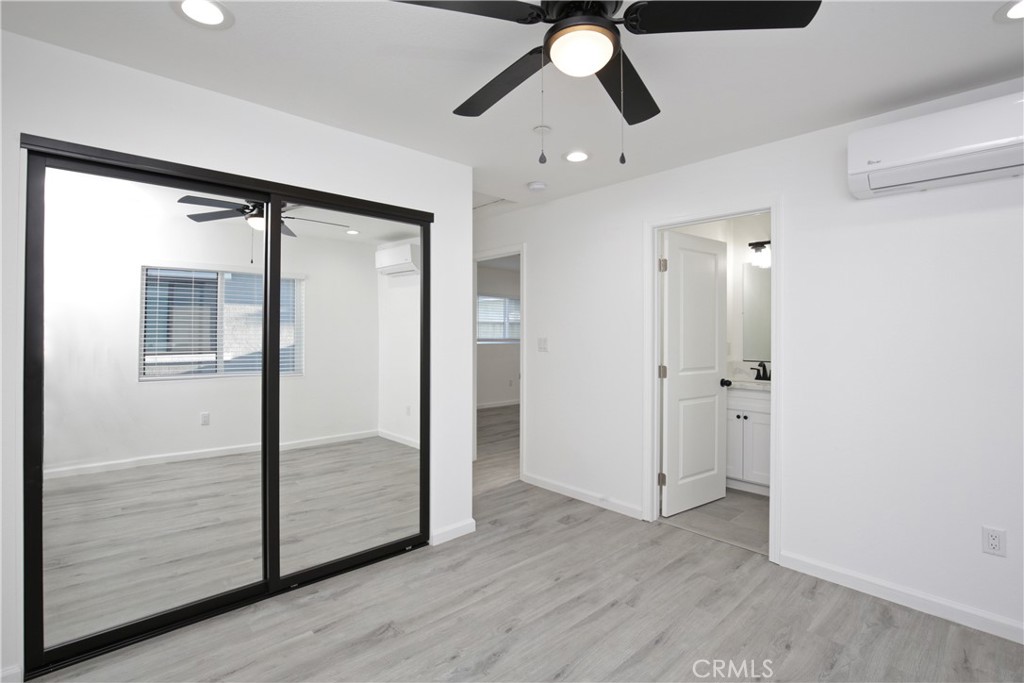 6147 Palm Avenue Riverside, CA 92506 - Photo 10 of 13 an empty room with wooden floor fan and windows