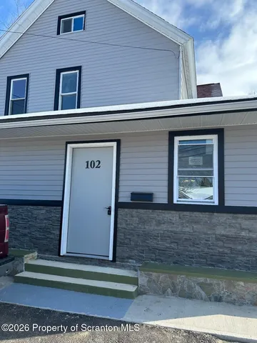 a front view of a house with stairs