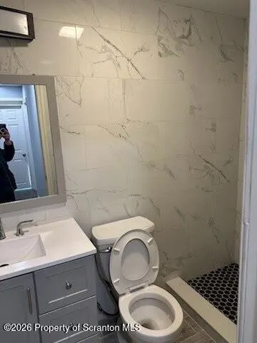 a bathroom with a sink toilet and a mirror