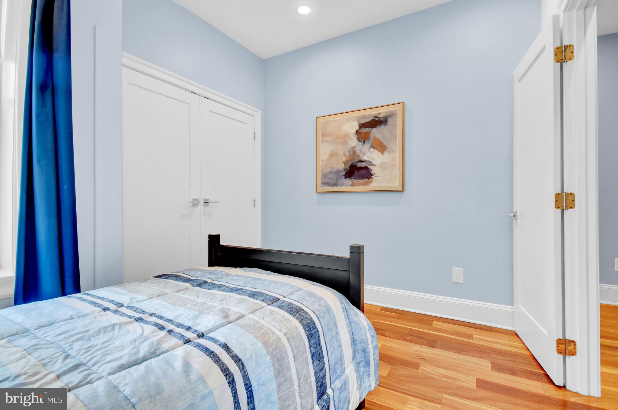 1915 2nd Street Northwest Washington, DC 20001 - Photo 37 of 76 a bedroom with a bed and a painting on the wall