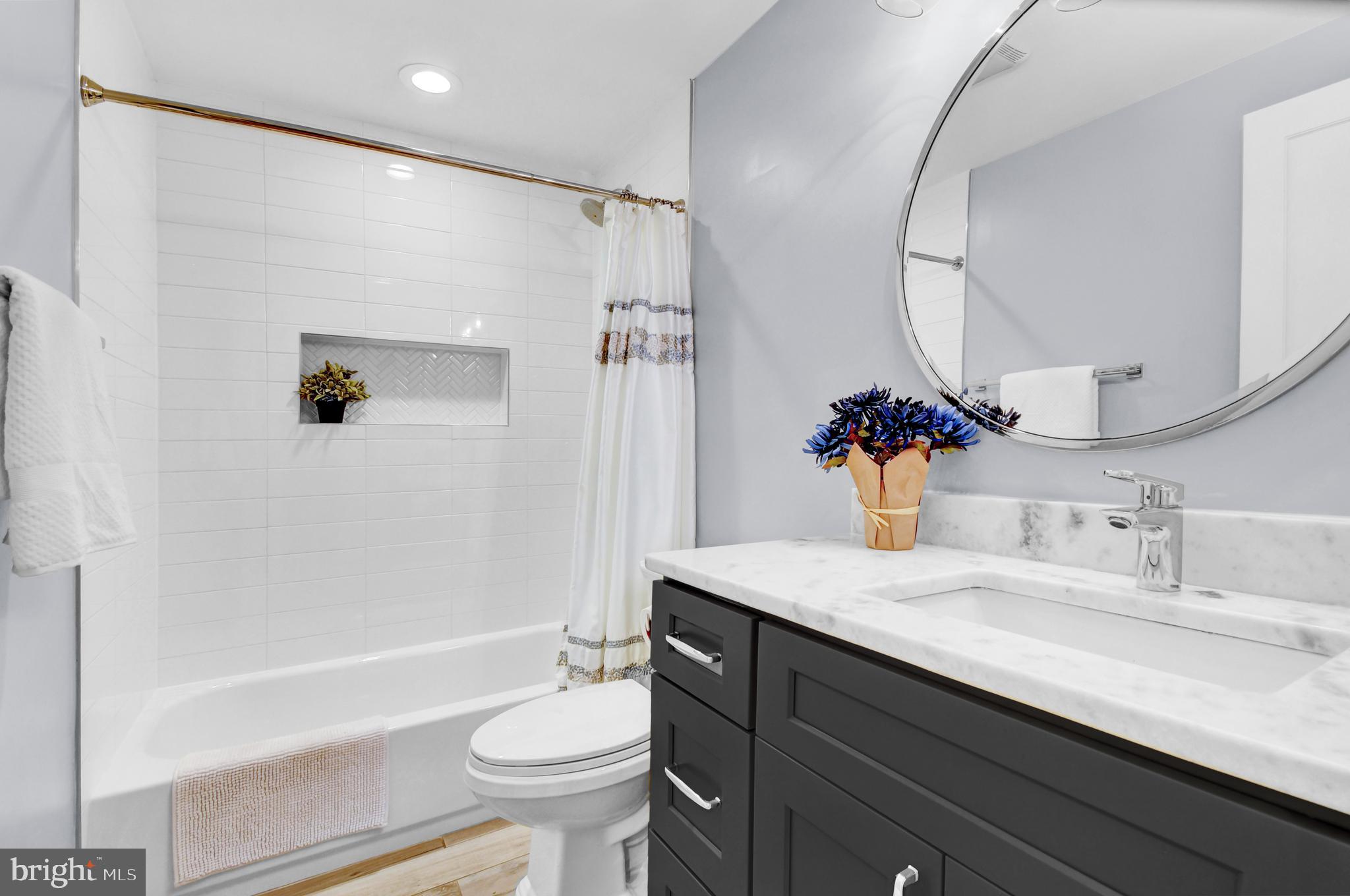 1915 2nd Street Northwest Washington, DC 20001 - Photo 53 of 76 a bathroom with a sink a toilet and a mirror