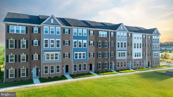 a front view of a residential apartment building with a yard